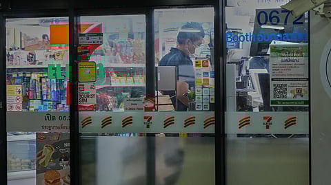A Thai customer lines up to pay money at a convenience store in Bangkok, Thailand, Wednesday, Dec. 3, 2025.