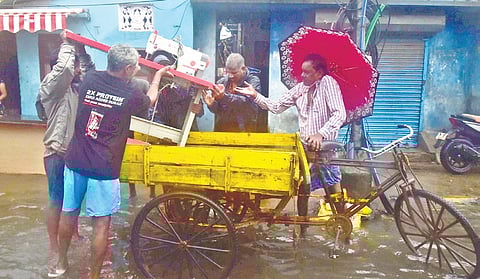 Residents of Vyasarpadi shifting their belongings to safer places from their flooded houses as rain lashed the city on Wednesday.