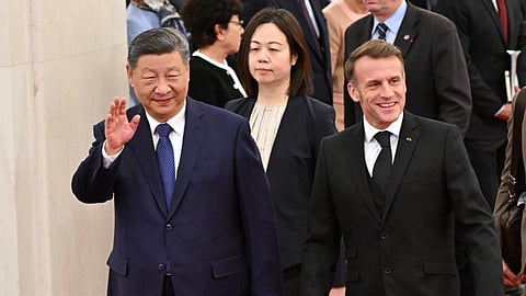 France's President Emmanuel Macron, right, and China's President Xi Jinping, left, walk during a state visit at the Great Hall of the People in Beijing Thursday, Dec. 4, 2025. 