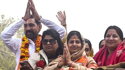 BJP candidate Rekha Rani from Dichaon Kalan celebrates her victory after winning MCD bypolls, in New Delhi on Wednesday.