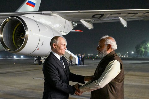 Russian President Vladimir Putin, left, and Indian Prime Minister Narendra Modi greet each other at the Palam Air Base in New Delhi, India, on Thursday, Dec. 4, 2025.