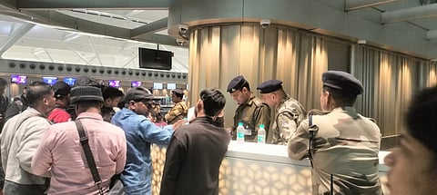 CISF personnel providing security to staff as passengers throng an IndiGo encounter at Delhi's Indira Gandhi International Airport. (Photo | Express)