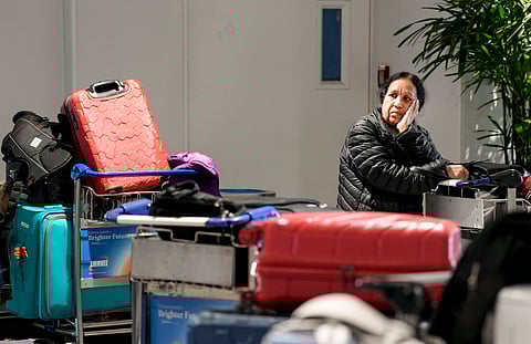 A stranded passenger waits at Terminal 1 (T1) of the Indira Gandhi International Airport, in New Delhi, Saturday, Dec. 6, 2025.