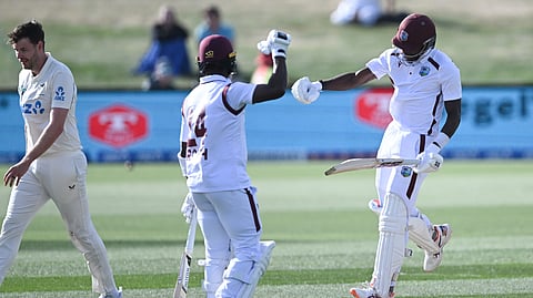 West Indies' Justin Greaves, right, celebrates with teammate Kemar Roach, center, after scoring 200 runs against New Zealand on Day 5 of their cricket test match in Christchurch, New Zealand, Saturday, Dec. 6, 2025. 