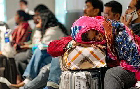 A passenger rests while waiting at Terminal 1 (T1) of the Indira Gandhi International Airport, in New Delhi, Saturday, Dec. 6, 2025. Domestic carrier IndiGo has cancelled over 200 flights from Delhi and Mumbai on Saturday, a day after managing to temporarily secure major relaxations in the second phase of the court-mandated new flight duty and rest period norms for cockpit crew, sources said.