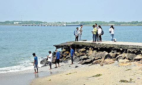 Tourists continue to tread over the breakwater at Fort Kochi beach, which is in a dilapidated condition, on Sunday.