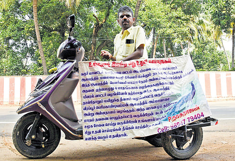 P Nagarajan, a polio survivor, travels around on his tricycle helping citizens draft petitions 
