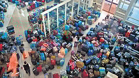 Passengers looking for their bags in the massive buildup of unclaimed luggage at IGI Airport on Sunday
