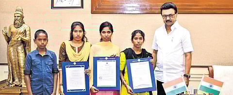 Chief Minister M K Stalin along with the four orphaned children from Poottai village in Kallakurichi who were presented with welfare aid on Monday.