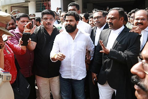 Malayalam actor Dileep emerges from the Ernakulam Principal Sessions Court, surrounded by media and fans, after being acquitted in the 2017 actor abduction case. 