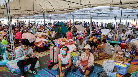 Evacuated Thai residents gather at a temporary shelter following clashes along the Thailand-Cambodia border in Buriram province on December 8, 2025.