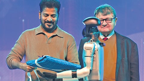 Chief Minister A Revanth Reddy receives the Telangana Rising Vision Document before unveiling it, at Bharat Future City on Tuesday.