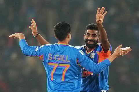 Jasprit Bumrah celebrates a wicket with Shubman Gill in the first T20I against South Africa in Cuttack. (Photo | AP)