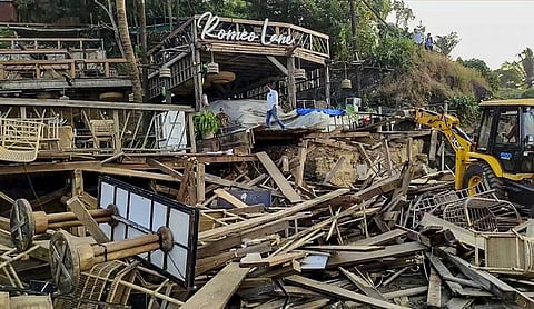 An excavator demolishes wooden structures at Romeo Lane on Anjuna beach after a fire at the adjacent Birch by Romeo Lane nightclub killed 25 people