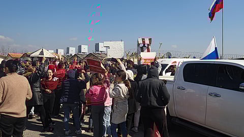 Members of the Alawite minority gather outside the Russian air base in Hmeimim, near Latakia in Syria's coastal region, March 11, 2025, as they seek refuge there after recent violence and retaliatory killings in the area.