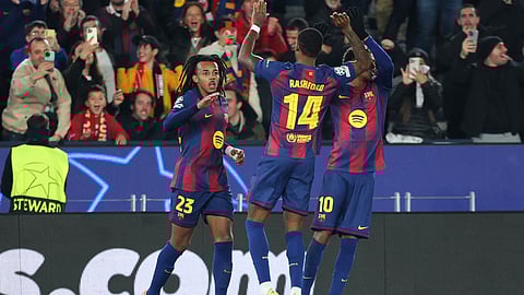 Barcelona's Jules Kounde (L) celebrates scoring his team's first goal during the UEFA Champions League league phase day 6 football match between FC Barcelona and Eintracht Frankfurt at Camp Nou Stadium in Barcelona on December 9, 2025.