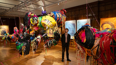 A person poses with an art installation entitled 'Conversations' by artist Nnena Kalu, which has been shortlisted for the Turner Prize, during a photocall at Cartwright Hall Art Gallery in Bradford, northern England on September 23, 2025.