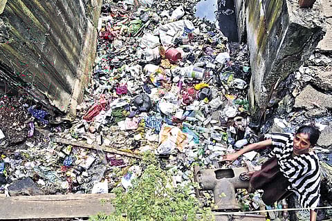 Mounds of plastic waste and garbage blocking the flow of Ekangipuram canal beneath the Murasoli Maran flyover.