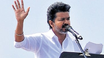 TVK chief Vijay addressing a massive crowd during the public meeting in Puducherry on Tuesday.