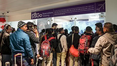 Passengers line up at an IndiGo Airlines ticket counter Delhi airport.