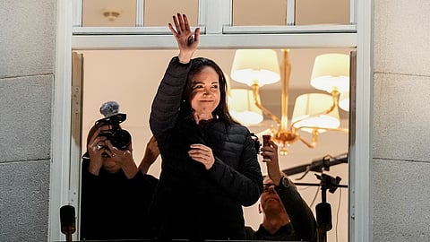 Nobel Peace Prize laureate Maria Corina Machado waves at the Grand Hotel in Oslo, Norway, early Thursday, Dec. 11, 2025.