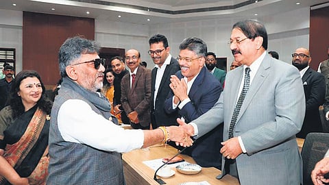 Deputy Chief Minister DK Shivakumar, along with MLC Dr Arathi Krishna, greets a delegation of NRIs from Karnataka at Suvarna Vidhana Soudha in Belagavi on Thursday   