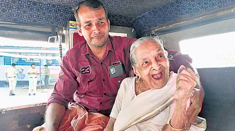 109-year-old Omana with her family member near the polling booth