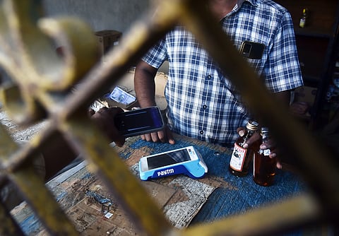  A customer uses the scanner to buy liquor from Tasmac at madipakkam in Chennai