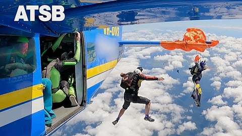 In this image taken from a video, a skydiver is caught on the wing of a plane as he exited the aircraft in Tully, North Queensland, Sept 20, 2025