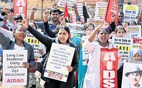 Students protest against the government’s proposal to convert two colleges into constituent colleges of Bangalore City University, on Friday 