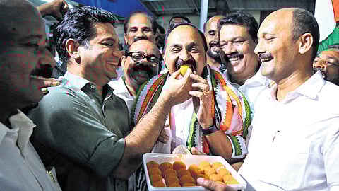 Congress MP Hibi Eden gives sweet to Leader of Opposition V D Satheesan after the UDF strong showing in the local body election.