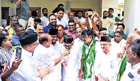 IUML national general secretary P K Kunhalikutty, celebrating UDF’s mammoth victory by sharing sweets with IUML state president Sayyid Sadiq Ali Shihab Thangal.