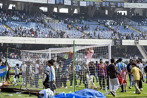 Angry fans on the field as they vandalise the Salt Lake Stadium, alleging poor management during Argentine footballer Lionel Messi's G.O.A.T India Tour 2025, in Kolkata 