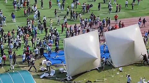 Angry fans on the field as they vandalise the Salt Lake Stadium, alleging poor management during Argentine footballer Lionel Messi's G.O.A.T India Tour 2025, in Kolkata on Saturday. 