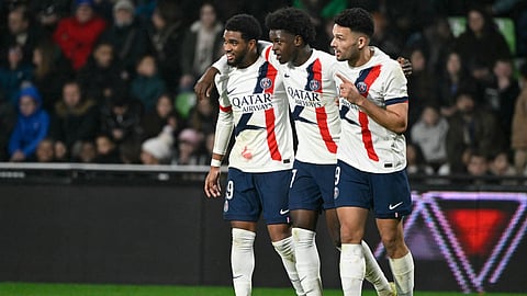 PSG's Quentin Enzo Leo Ndjantou Mbitcha (C) is congratulated by his teammates Ibrahim Mbaye (L) and Goncalo Ramos after scoring a goal during the French L1 football match between Metz and Paris Saint-Germain on December 13, 2025.