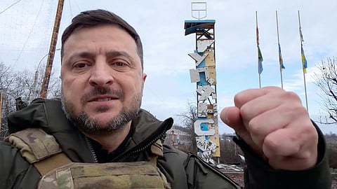 In this image made from a video provided by the Press Service of the President of Ukraine on Friday, Dec. 12, 2025, Ukraine's President Volodymyr Zelenskyy records a video at the entrance of a road in Kupiansk, Ukraine.