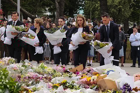People leave notes at a flower tribute for shooting victims outside the Bondi Pavilion at Sydney's Bondi Beach, Monday, Dec. 15, 2025, a day after a shooting. 