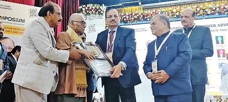 CJI Surya Kant felicilating senior advocate Darpa Hari Dhal during the symposium in Cuttack 