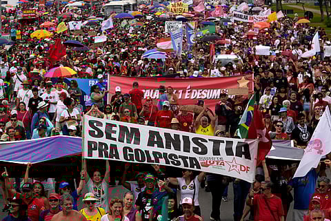 Demonstrators protest a bill that looks to reduce former President Jair Bolsonaro's prison time, in Brasilia, Brazil, Sunday, Dec. 14, 2025. 