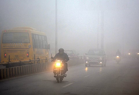Commuters move through dense fog on a winter morning, in Varanasi, Tuesday, Dec. 16, 2025.