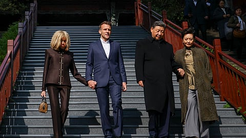 French President Emmanuel Macron (2nd L), his wife Brigitte Macron (L), Chinese President Xi Jinping (2nd R), and his wife Peng Liyuan (R) visit the Dujiangyan site, a designated UNESCO World Heritage site, in Dujiangyan, in southwestern China's Sichuan province, on December 5, 2025.