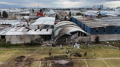 Rescue workers inspect the site of a plane crash near Toluca airport in San Mateo Atenco, Monday, Dec. 15, 2025