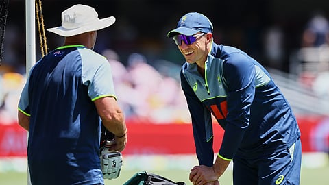 Australia's Pat Cummins, right, warms up before the start of the second Ashes cricket test match between Australia and England in Brisbane, Thursday, Dec. 4, 2025.