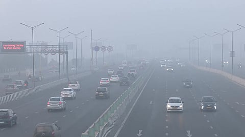 Vehicles commute through the Akshardham area covered with smog amid worsening air quality in New Delhi.