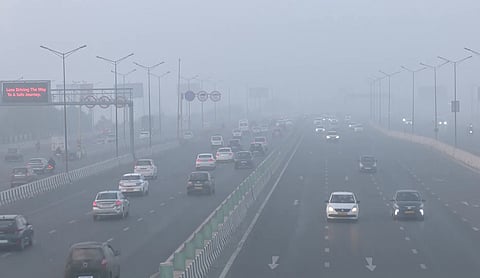 Vehicles commute through the Akshardham area covered with smog amid worsening air quality in New Delhi, Dec. 16, 2025.