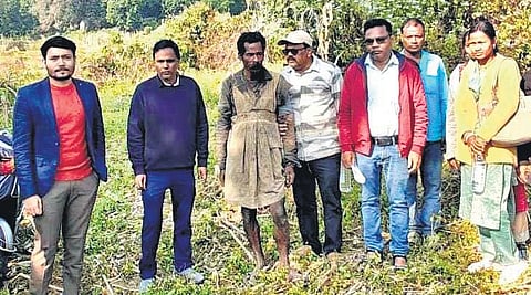 Officials with 60-year-old Dukha Naik after his rescue on Wednesday.
