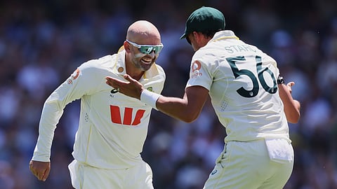 Australia's Nathan Lyon, left, celebrates with teammate Mitchell Starc after dismissing England's Ben Duckett.
