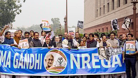 Leader of Opposition in the Rajya Sabha Mallikarjun Kharge, Congress MPs Sonia Gandhi, KC Venugopal and Hibi Eden, Samajwadi Party (SP) MP Dharmendra Yadav, DMK MP TR Baalu and other opposition members raise slogans during a protest at the Parliament House complex amid its ongoing Winter session, in New Delhi, Thursday, Dec. 18, 2025. 
