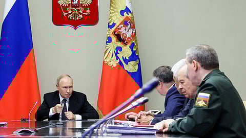 Russian President Vladimir Putin, left, leads a meeting with top security and defense officials at the Novo-Ogaryovo state residence outside of Moscow, Aug. 12, 2024.