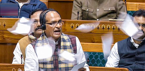 Union Minister Shivraj Singh Chouhan speaks in the Lok Sabha as opposition members throw papers in protest during the Winter session of Parliament, in New Delhi, Thursday, Dec. 18, 2025.